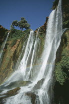 Waterfalls of the Olives.  Multiple falls cascading over rocks with sunlight through spray causing rainbow effect.