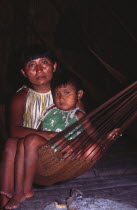 Warao Indian woman with daughter in hammock.