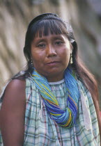 Warao Indian woman  wearing many beaded necklaces.