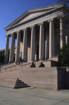 Entrance to the National Gallery of Art  people sat on the steps.