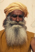 Indian guru  with long beard and yellow head-dress.