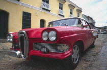 A classic red US 1950s car.