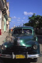 A classic green US 1950s car  parked on the Malecon.