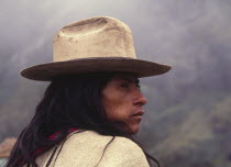 Ica Indian chewing coca  wearing a hat and looking to his right.