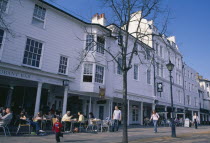 England, Kent, Tunbridge Wells, The Pantiles. Cafe with outside seating and people sat at tables.