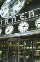 Exterior of Tourneau watch shop with clock displays above the entrance.