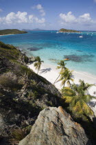 View over the beach of Jamesby Island and moored yachts towards Canouan on the horizon