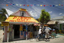 Men talking outside pizza restaurant and tourist shop in Clifton