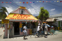 Men talking outside pizza restaurant and tourist shop in Clifton