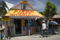 Men talking outside pizza restaurant and tourist shop in Clifton