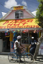 Men talking outside pizza restaurant and tourist shop in Clifton