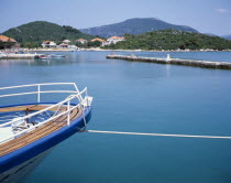 Prow of a moored boat with coastline beyond