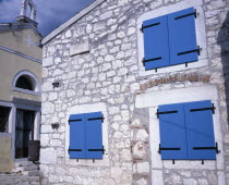 Old town church and cottage with blue painted shuttered windowsRovigno  Rovigno