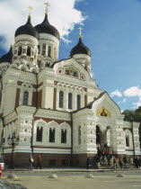 Alexander Nevsky Cathedral with people sitting on steps at the entrance.