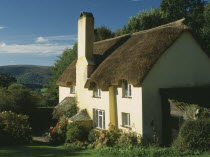 Thatched cottage with mullioned windows.