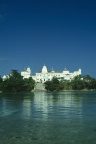 The castle an ornate white building with wide steps leading down to the sea