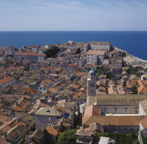 View over rooftops towards sea.