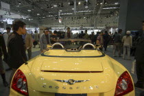 Tokyo Auto Show  people looking at a yellow Chrylser Crossfire convertibleCar Automobile