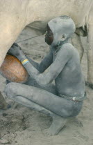 Milking cow in Dinka cattle camp.