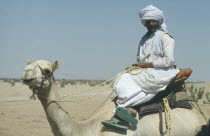 Cropped shot of Ababda nomad man on camel.