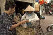 Lady selling peanuts from her bicycle