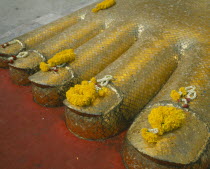 Wat Indrawiharn. Close up of Floral offerings on the toes of a 45 meter high Gold Buddha.