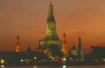 Wat Arun  The Temple of  Dawn  on the bank of the Chao Phraya River  lit up at dusk.