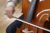 Teenage Cello player. Detail of cello and hand     Akimitsu Suzuki 18yrs old