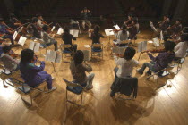 United Freedom Orchestra rehearsing for spring concert Junior and senior high school students  13 to 18 years old  top center is conductor and music teacher Satoshi Miyano