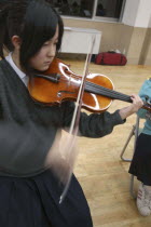 Teenage high school girl playing violin in United Freedom Orchestra  17 year old