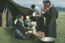 Tibetan nomad women on the high grasslands with cream seperator brought by travelling salesman.