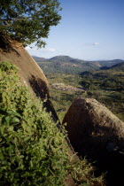 View over village huts and countryside.