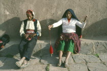 Taquile.  Couple weaving.