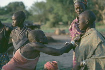 Dinka blessing with oil.