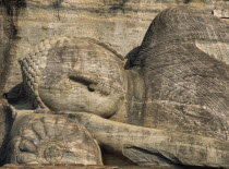 Gal Vihara.  Mid twelth century reclining Buddha figure shown at the moment of entry into nirvana and carved from granite.  Detail of head and face.11th -13th Century capital