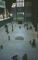 Tate Modern. View over the Old Turbine Hall with modern sculpture exhibits and visitors  Art Galleries