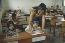 Teacher and infants in UNHCR school for Hmong returnees