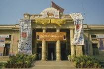 Political posters hanging outside columned building entrance