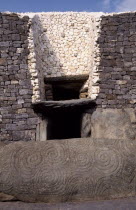 Entrance to Prehistoric Burial Site in the Boyne Valley with carved stone in the foreground