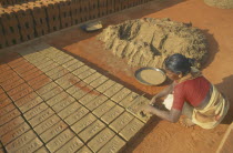 Woman making bricks in a brick works