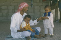 Bedouin man with his two young children.