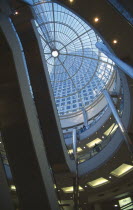 Canary Wharf . Cabot Square Shopping area showing the escalators and glass atrium with the 1 Canada Square tower visible.