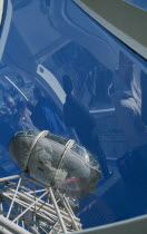 British Airways London Eye. View of pods with people inside the capsule reflected in the curved glass.