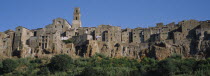 Built on cliffs above Lente Valley with caves made during etruscan era.