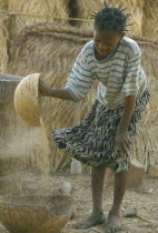 Near Garango. Young girl winnowing.GGirl called Mariam