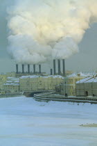 Industrial chimneys emitting thick smoke over Moscow in snow.Air pollution