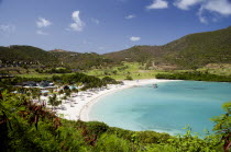 Jambu Beach in Carenage Bay at Raffles Resort with the Trump International Golf Course behind