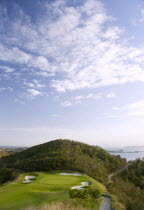 Raffles Resort showing the 12th green on the Trump International Golf course with the southern Grenadine islands in the distance