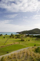 Raffles Resort showing part of the Trump International Golf course beside Carenage Bay