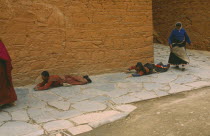 Tibetan pilgrims prostrating themselves on the ground.